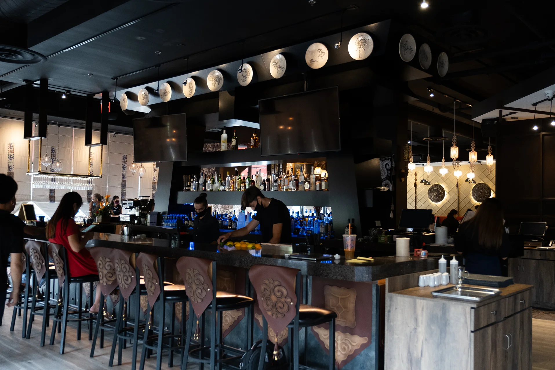 Modern bar interior with stylish decor and bartenders at work