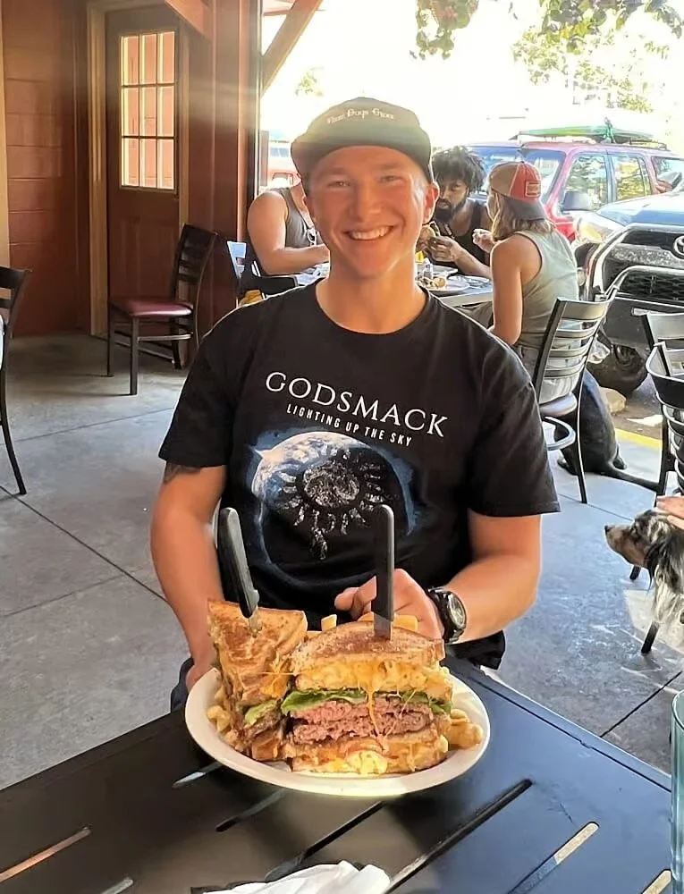 Giant cheeseburger with toasted bread in a casual dining setting