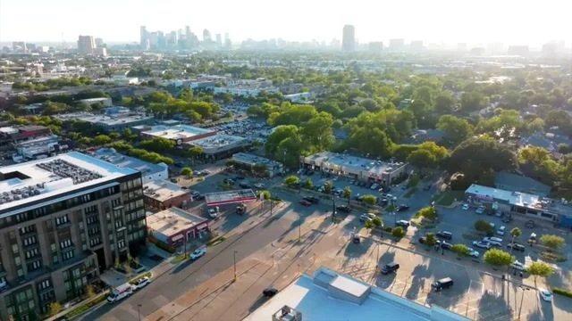 Aerial view of a vibrant urban landscape with greenery and city skyline