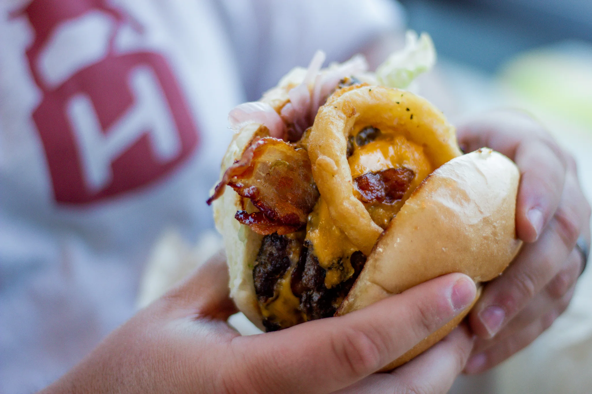 Juicy American cheeseburger with bacon and onion rings