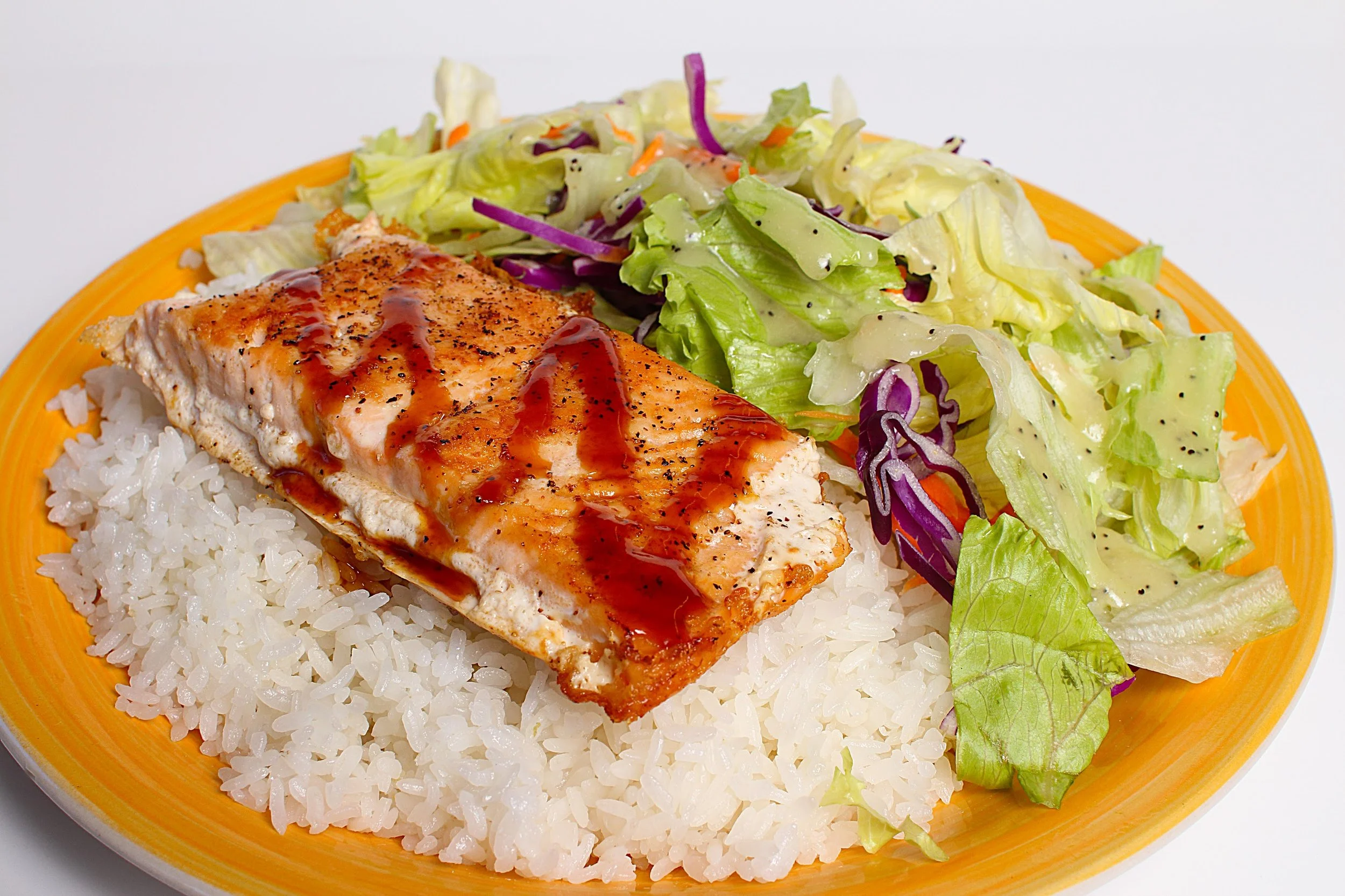 Two packets of teriyaki sauce placed on branded paper with a repeating pattern of food and chopsticks.
