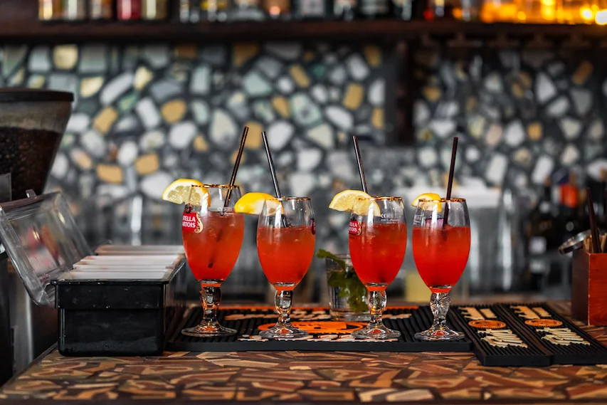 Colorful cocktails with lemon garnish at a stylish bar