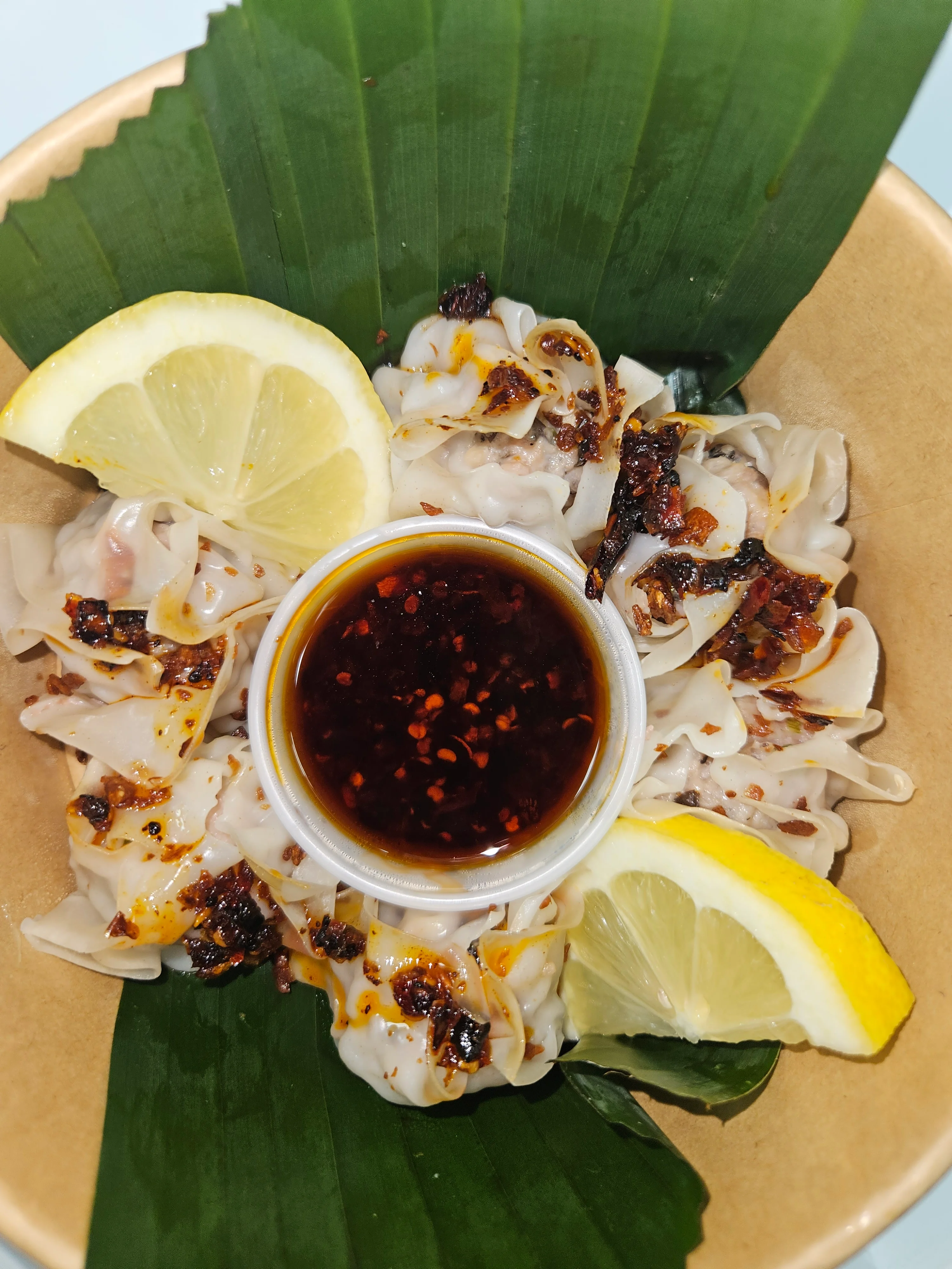 Delicious Chinese dumplings with spicy dipping sauce
