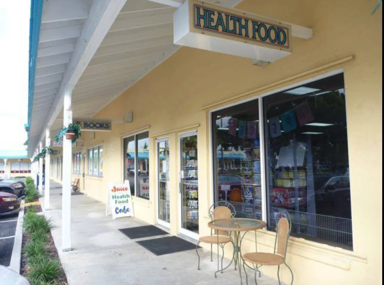 Health food cafe exterior with seating area