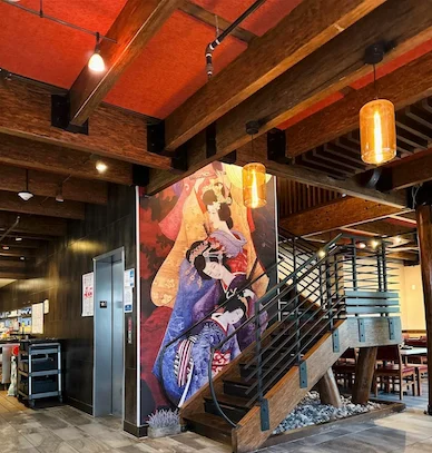 Stylish restaurant interior with wooden beams and vibrant wall art