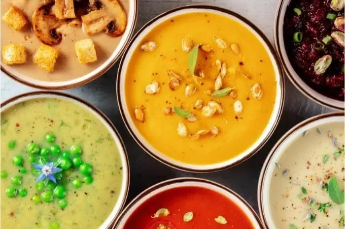 Assorted gourmet soups in bowls, showcasing global flavors