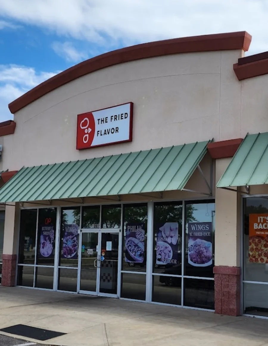 Exterior of The Fried Flavor restaurant with signage and menu displays