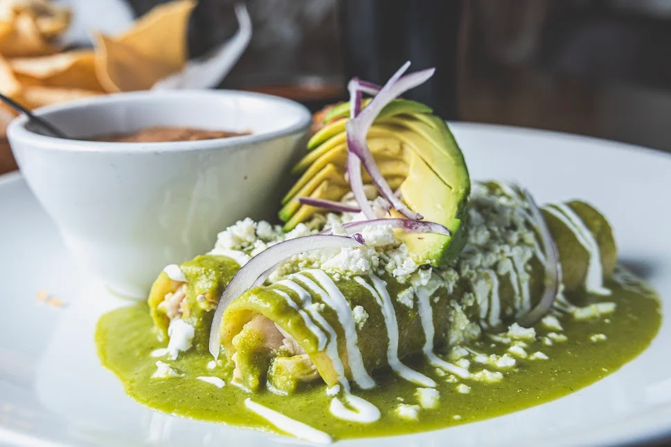 Green enchiladas with avocado and crema