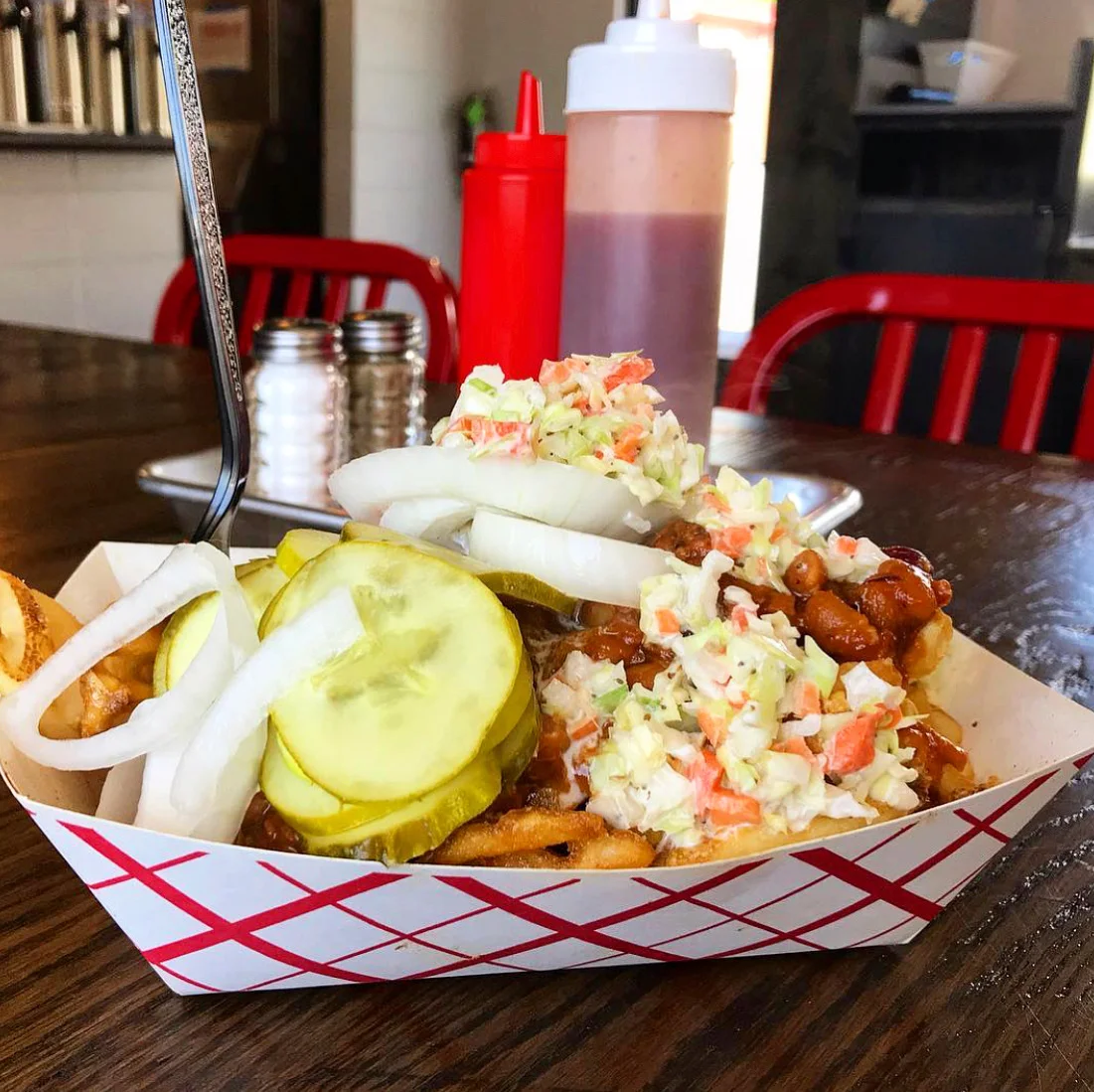 Delicious burger with toppings served on a wooden table