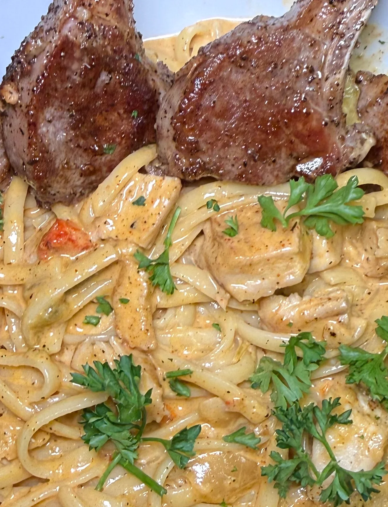 Lamb chops served over Cajun-style pasta at The Marquee