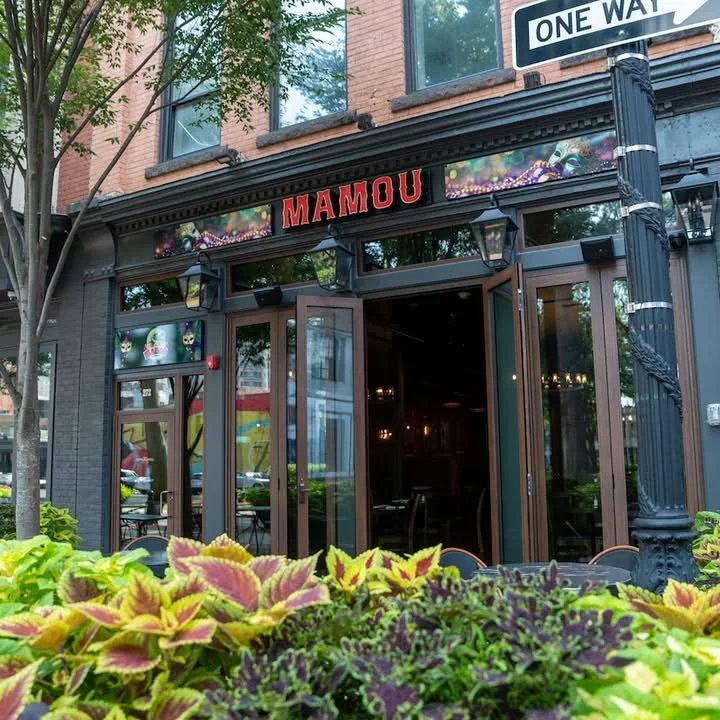 Charming restaurant exterior with vibrant signage and greenery