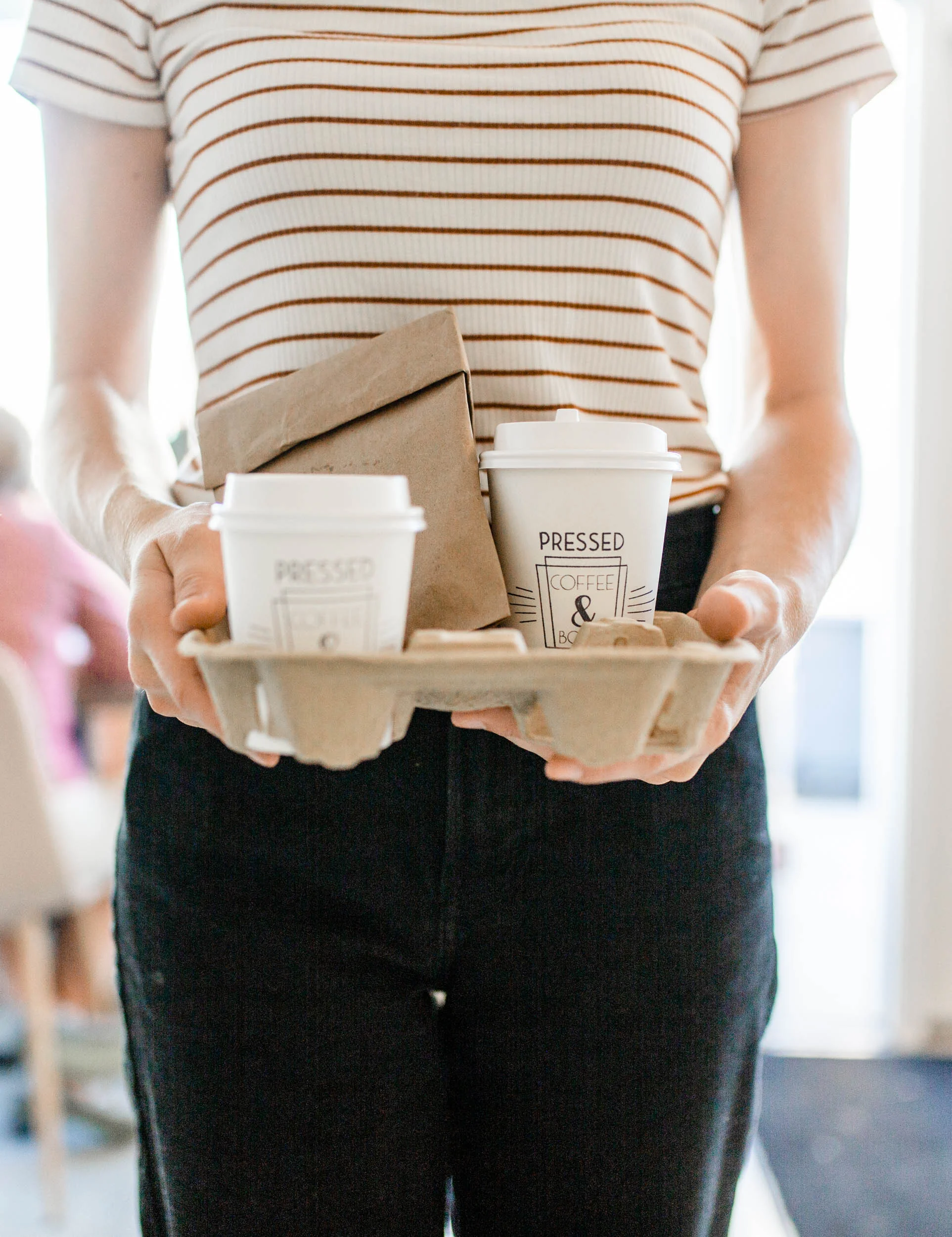 Coffee and pastries in takeout containers from a café