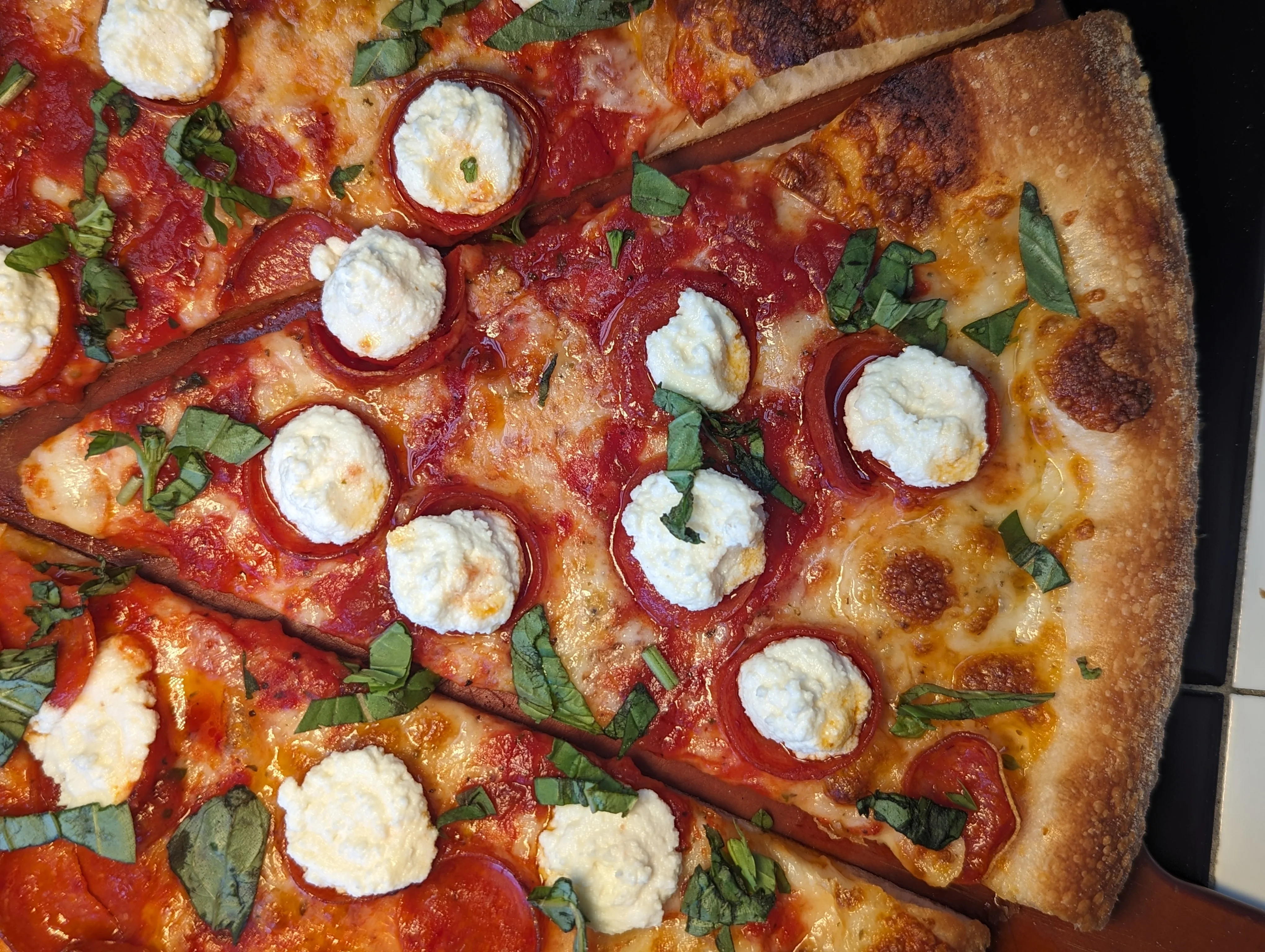 An extra cheesy and saucy pizza slice