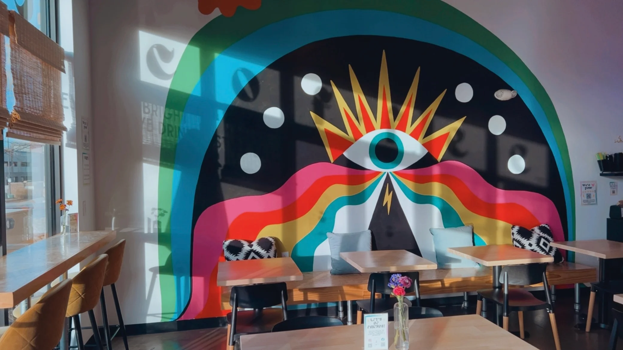 Vibrant restaurant interior with colorful mural and cozy seating