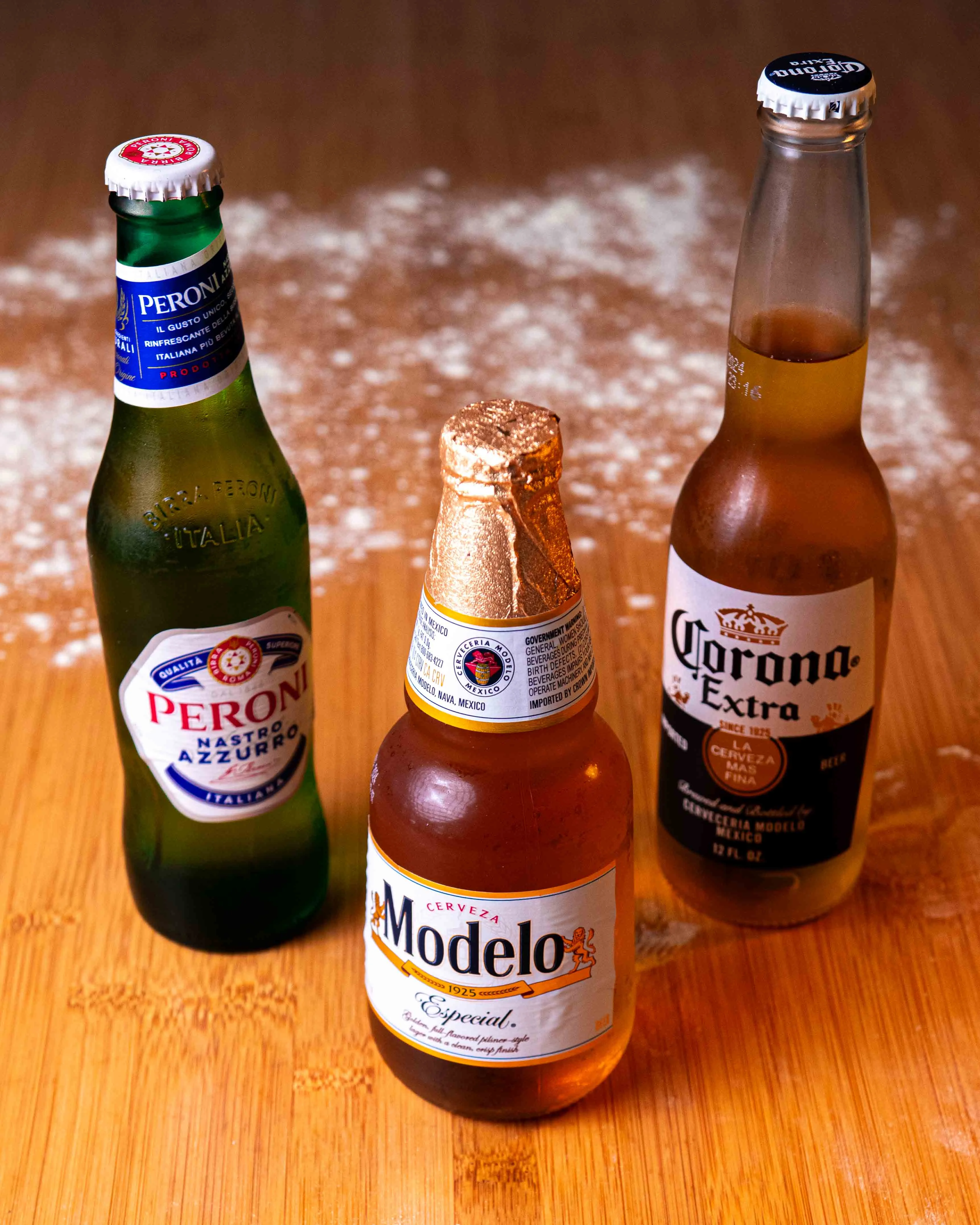 Selection of popular Mexican and Italian beers on a wooden surface