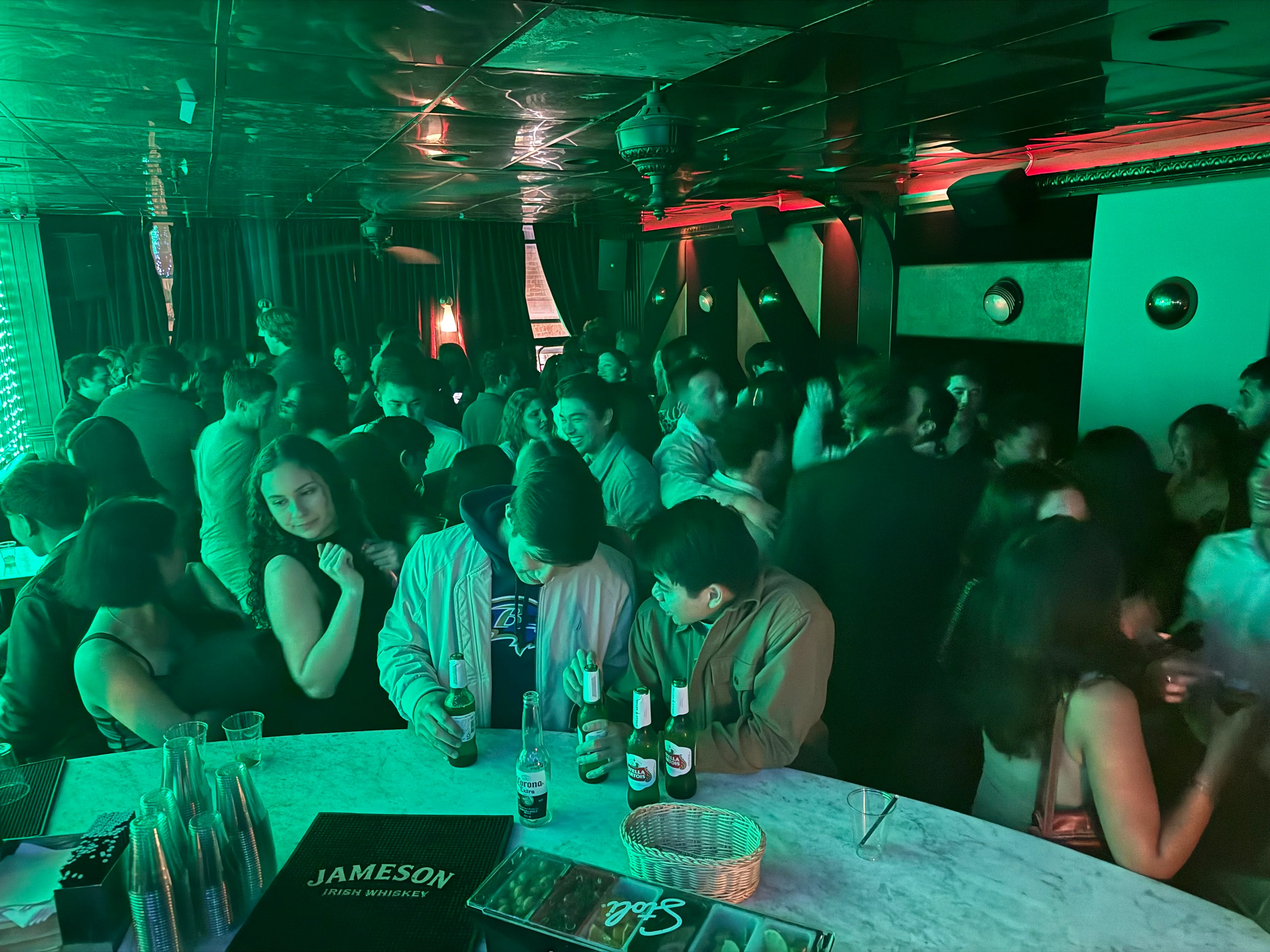 Vibrant nightlife scene in a crowded bar with green lighting