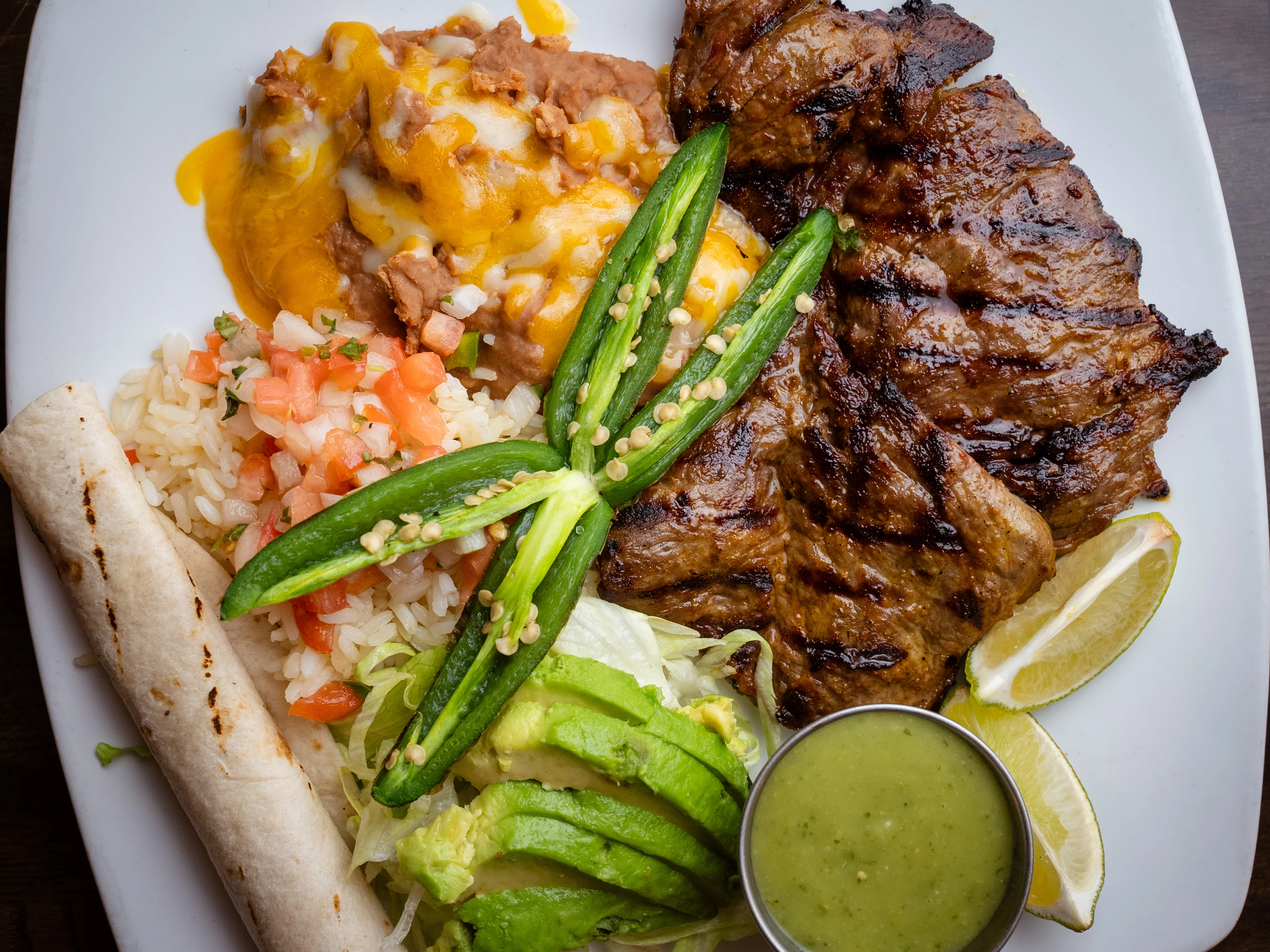 Grilled carne asada platter with rice and beans