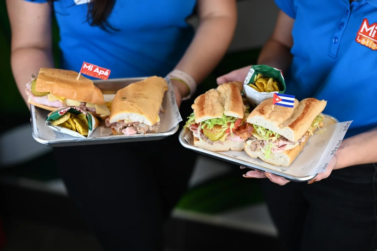 staff presenting cuban sandwich and miami sandwich