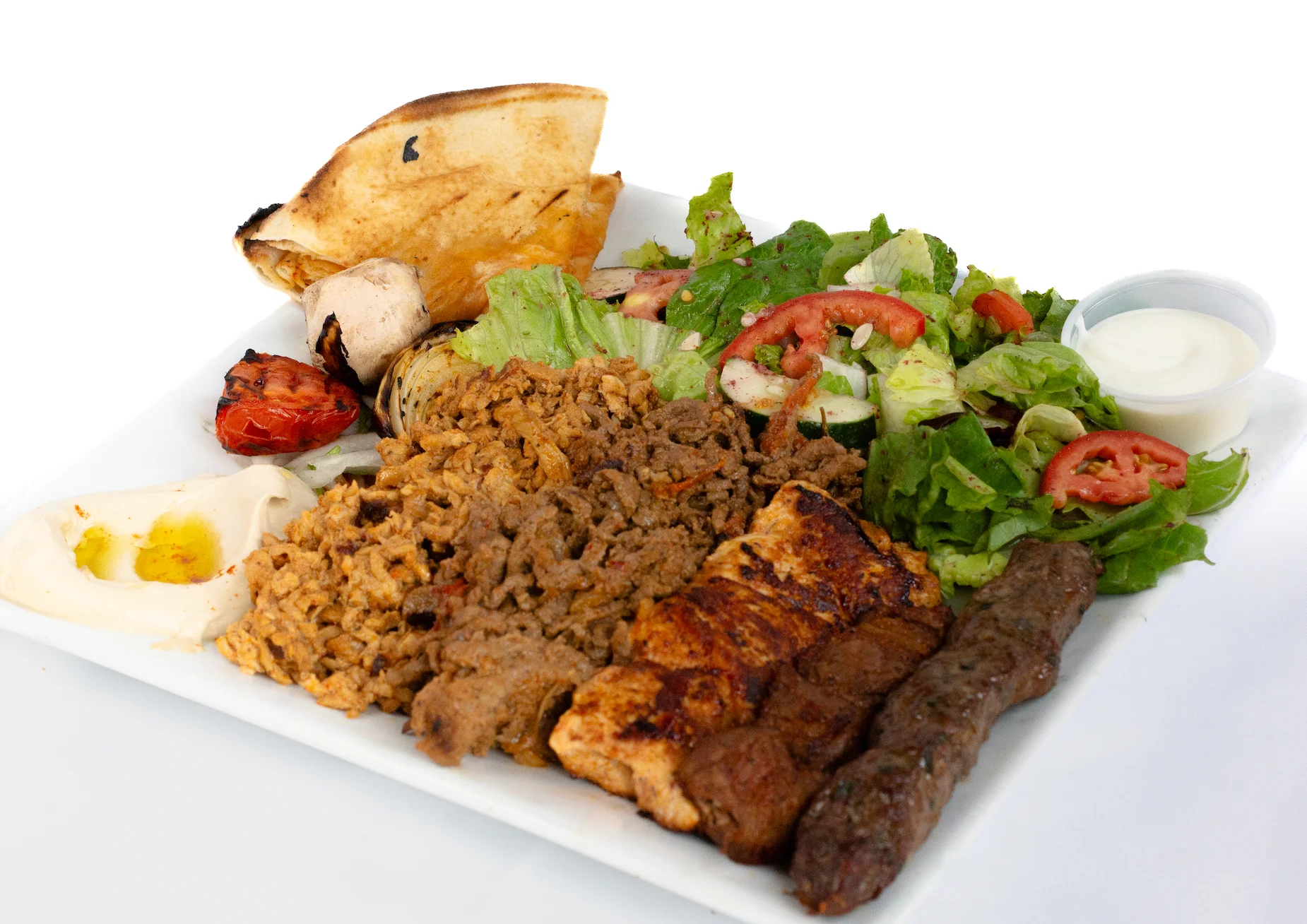 Mediterranean mixed grill platter with kebabs and fresh salad