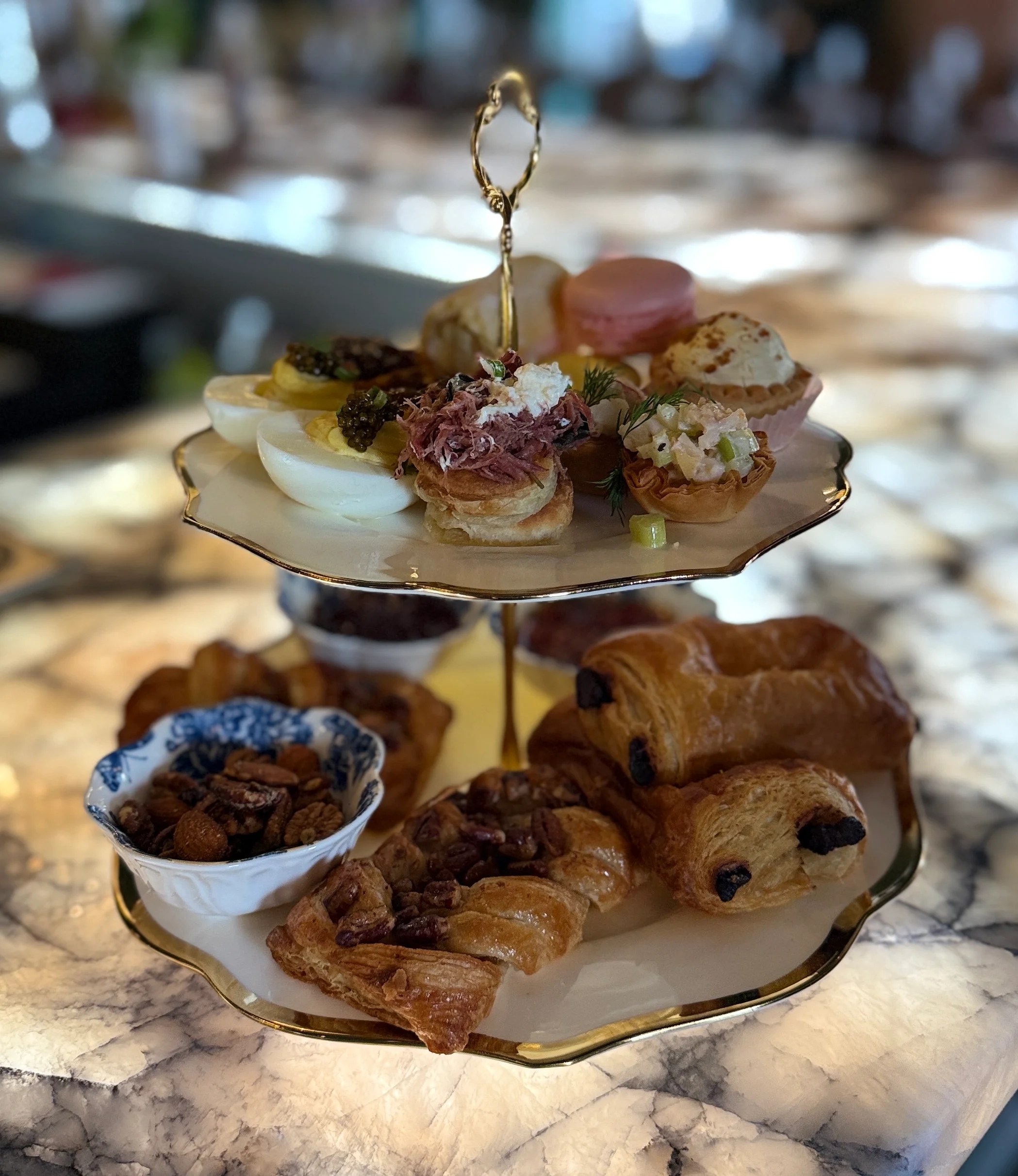 Elegant afternoon tea stand with assorted pastries and savory bites