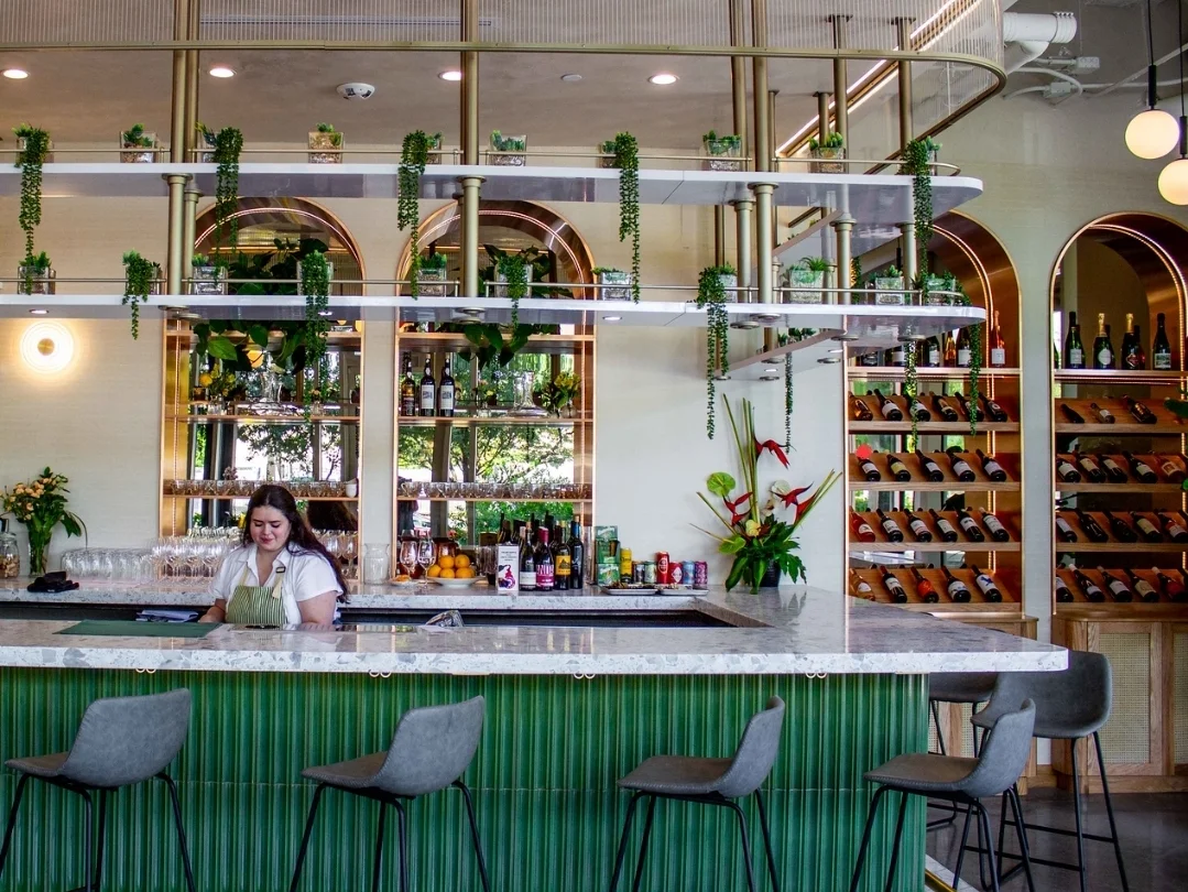 Elegant bar display with wine bottles and books in a modern restaurant