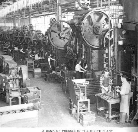Historic factory scene with large machinery and workers