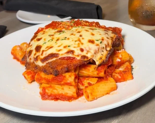 Italian chicken parmesan with rigatoni pasta in marinara sauce
