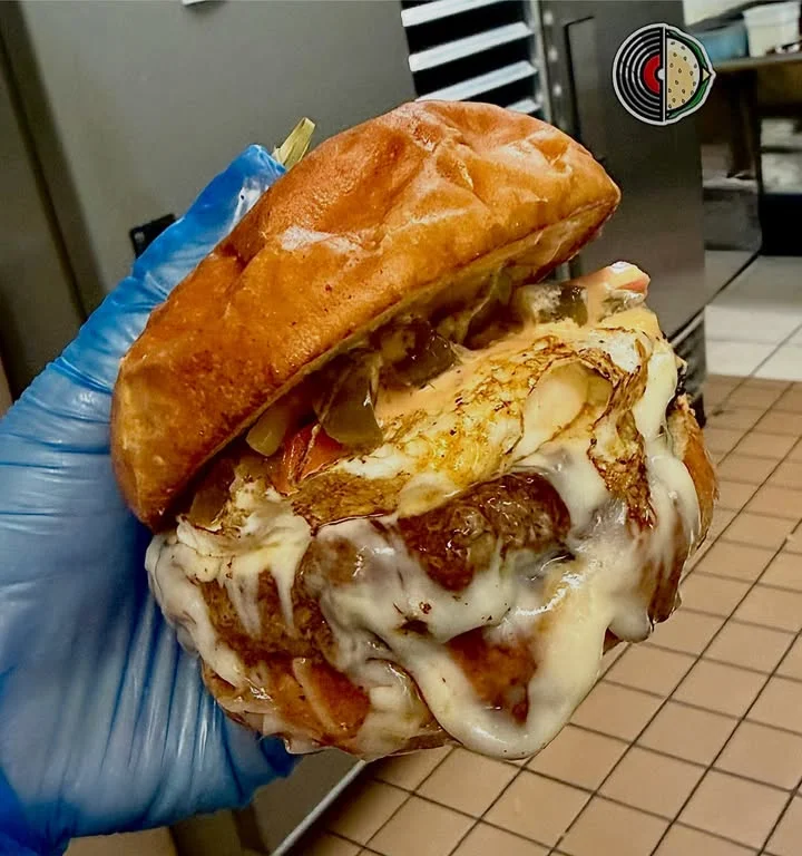 Melted cheese burger with fried egg and pickles