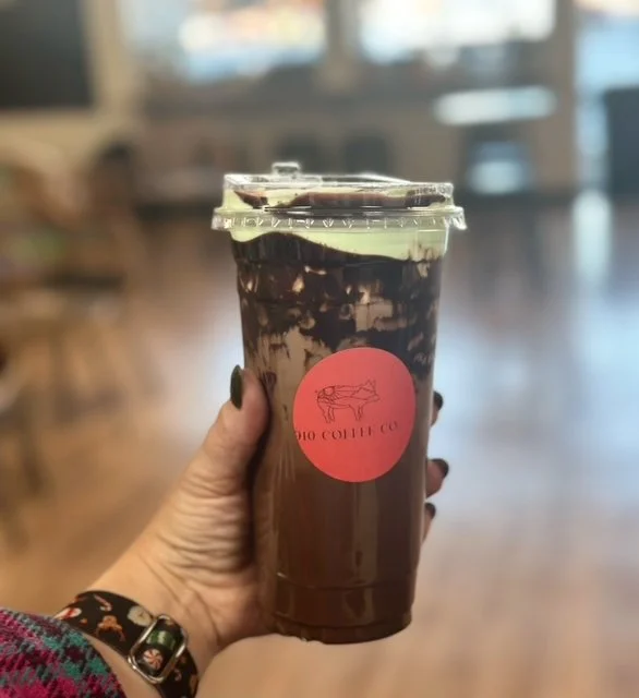 Iced chocolate drink with whipped cream in a cafe setting