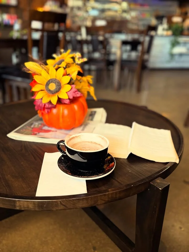 Cozy café table with hot chocolate and autumn decor