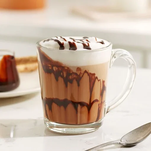 Delicious mocha latte topped with whipped cream and chocolate drizzle