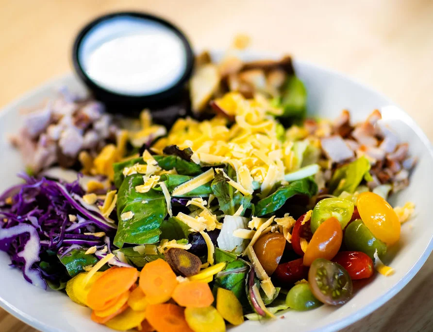 Colorful garden salad with grilled chicken and ranch dressing