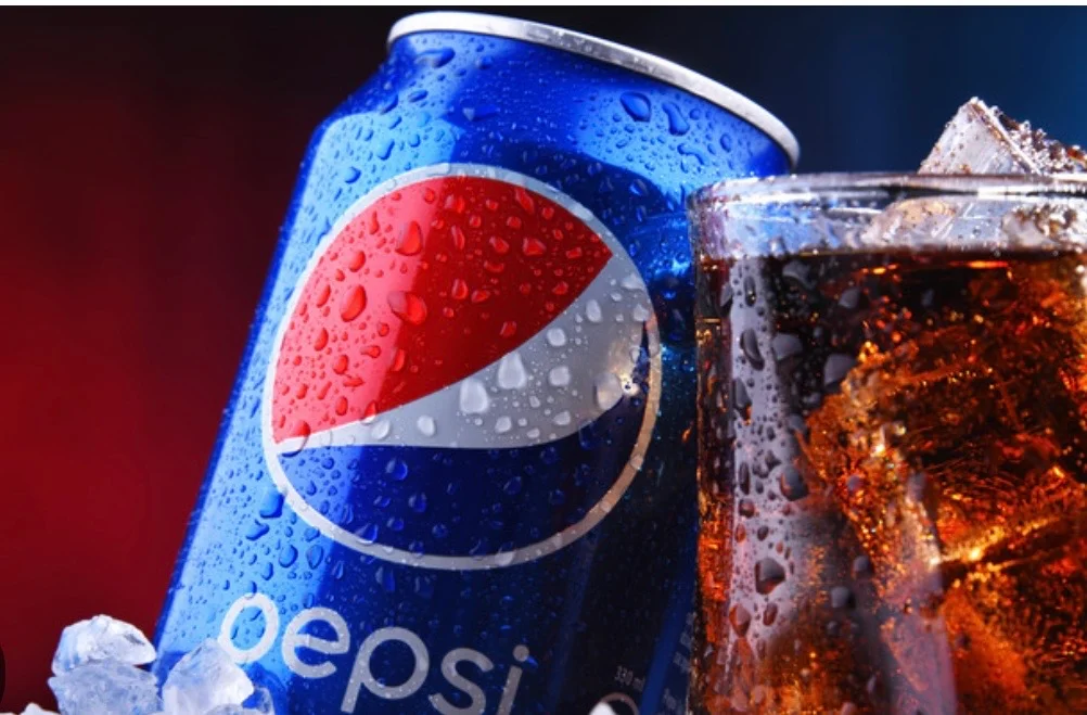Chilled can of Pepsi with ice-cold cola in a glass