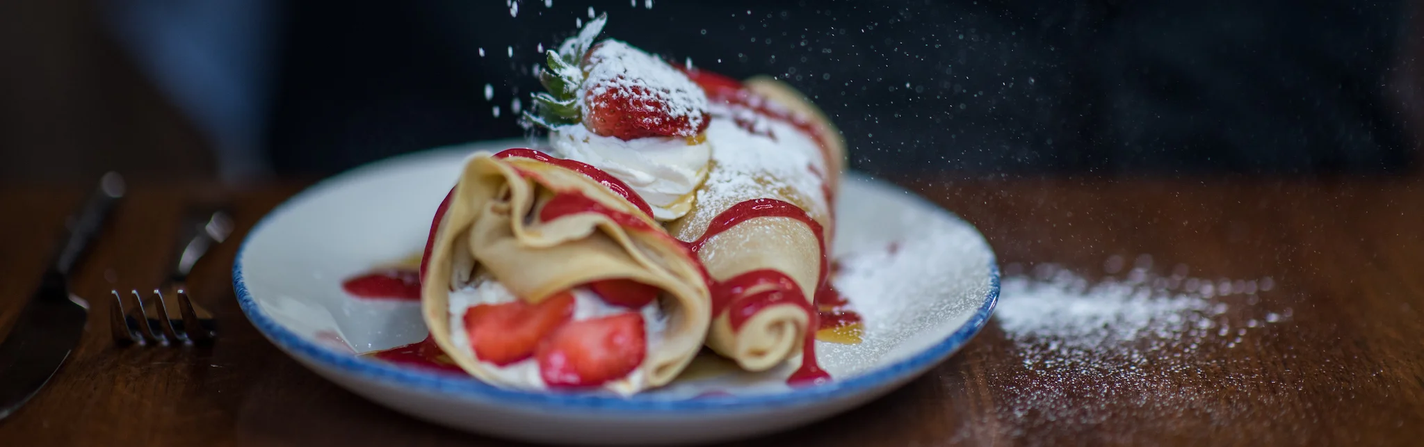 Delicious French crêpes with strawberries and whipped cream