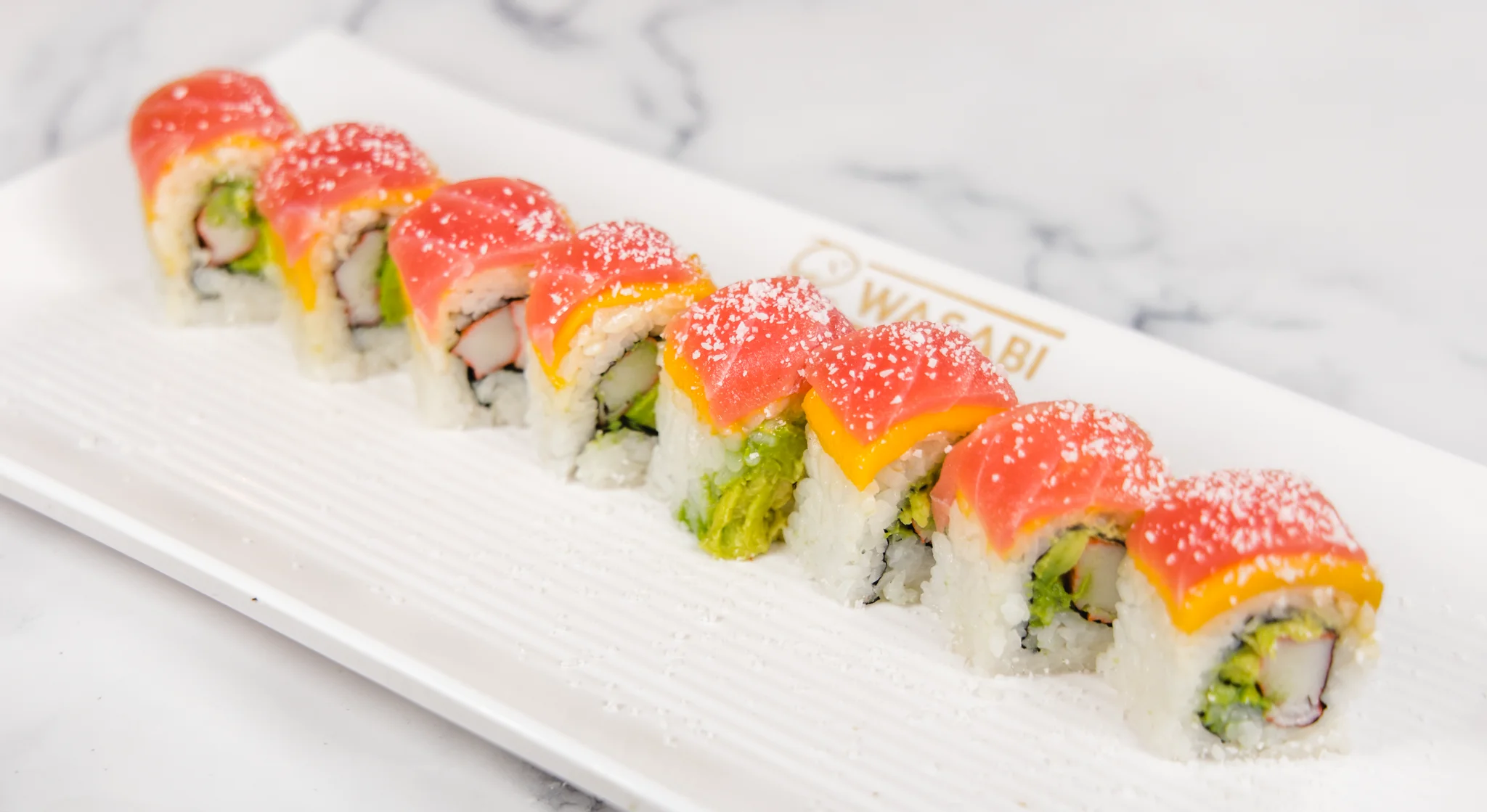 Colorful sushi rolls on a white plate