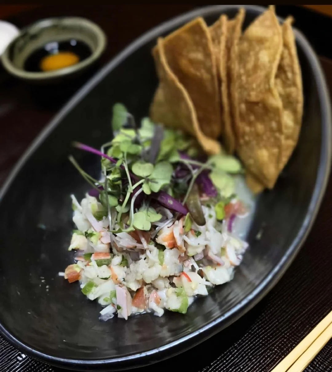Ceviche with crispy tortilla chips in a stylish presentation