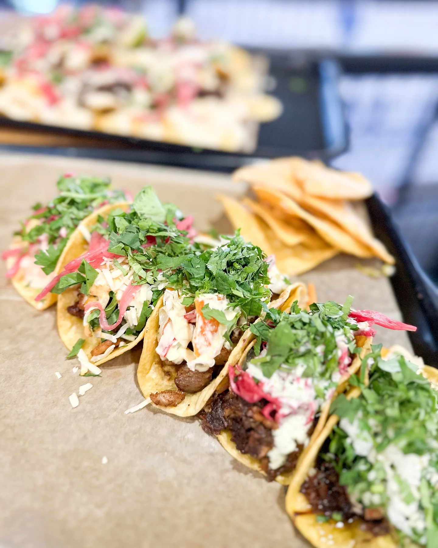 Delicious Mexican tacos topped with fresh cilantro and pickled onions