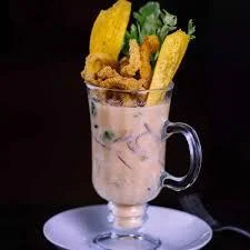 Peruvian ceviche served in a glass with plantains