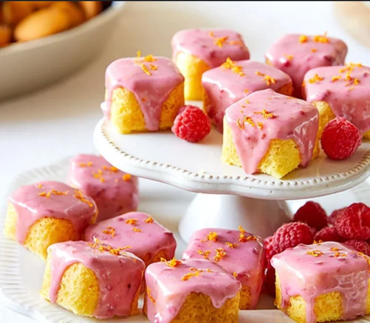 Delicious raspberry glazed mini cakes on a decorative stand