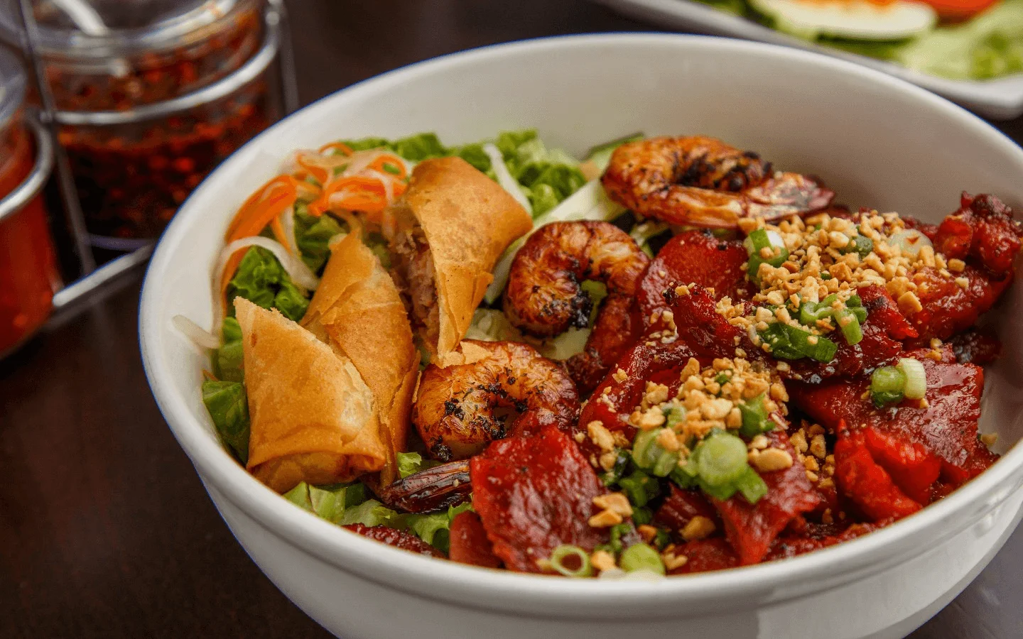 Vietnamese shrimp salad bowl with spring rolls