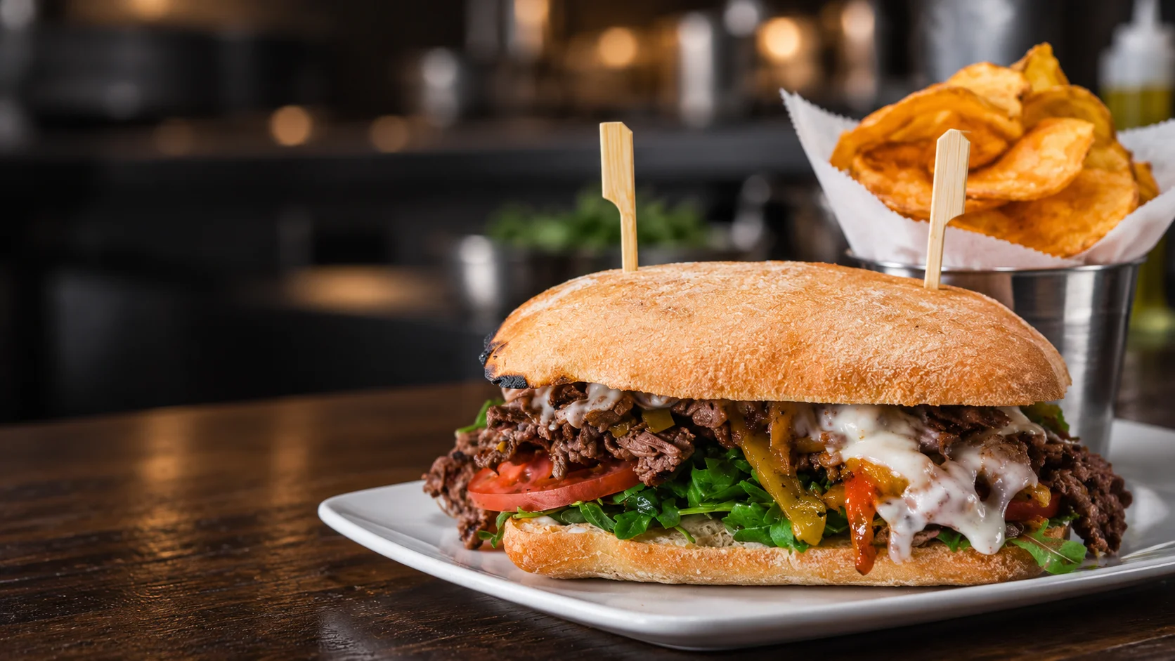 Steak sandwich at Wild Carvery in Burbank with sliced steak, melted cheese, peppers, tomato and arugula