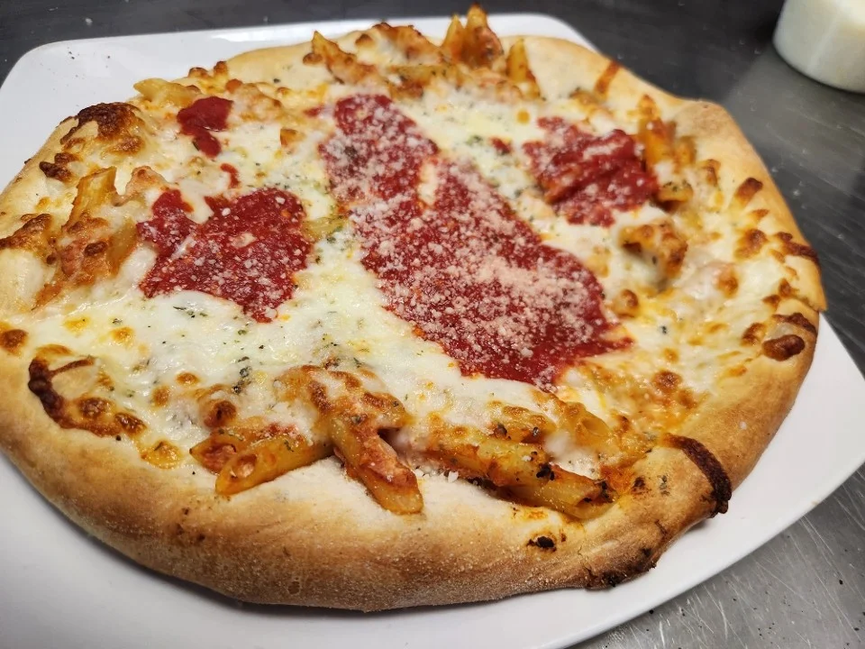 Baked ziti pizza topped with marinara and mozzarella
