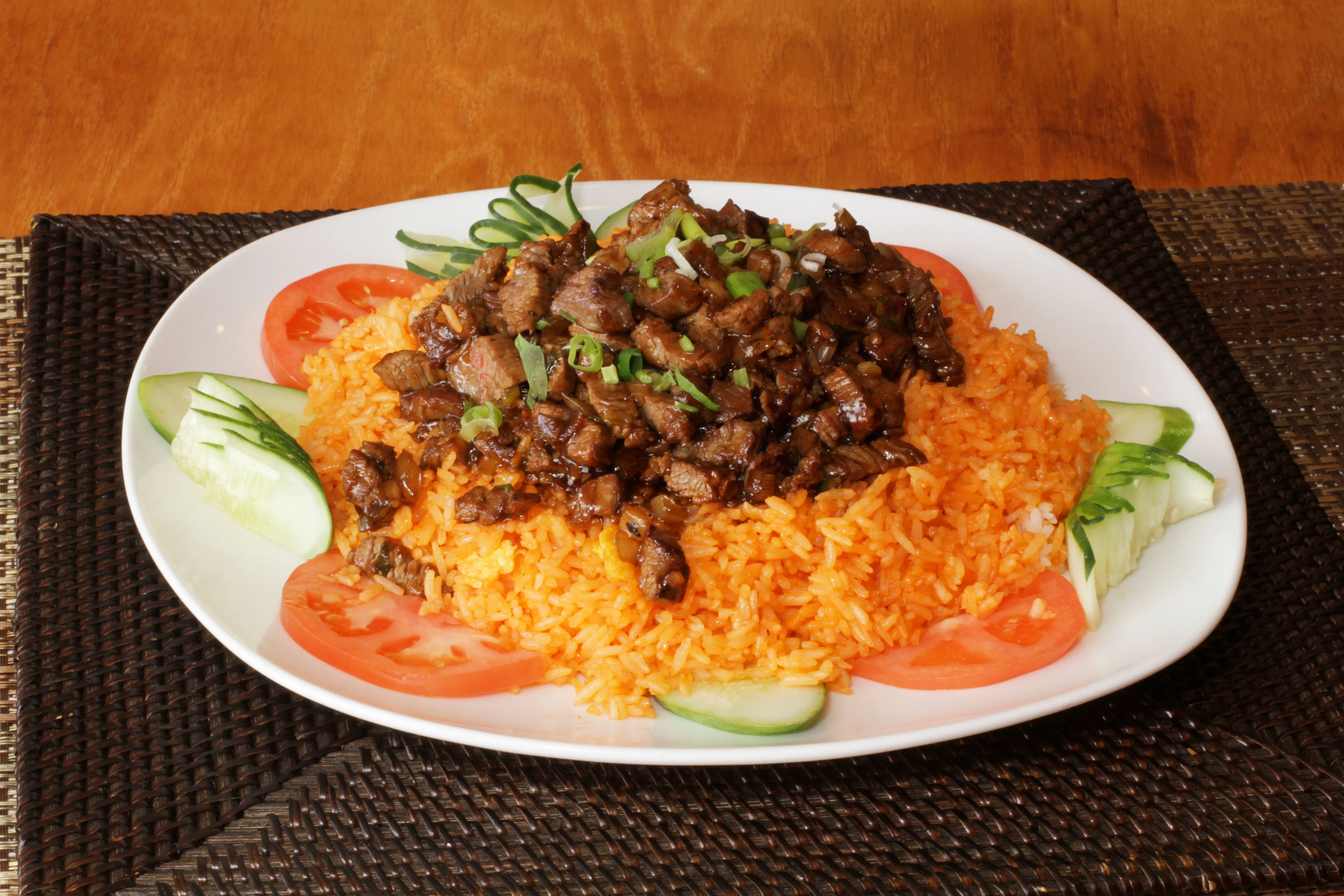 Nigerian jollof rice topped with grilled beef