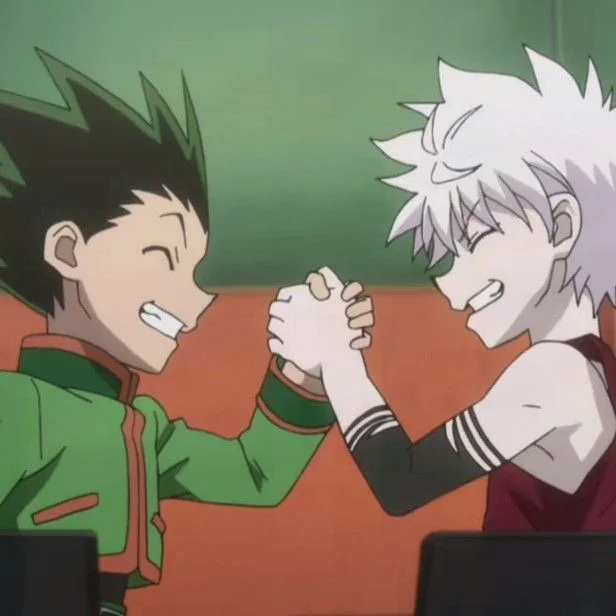 Two animated characters engaged in a friendly arm wrestling match, both smiling confidently. One has spiky green hair and the other has white hair, showcasing their playful competition.
