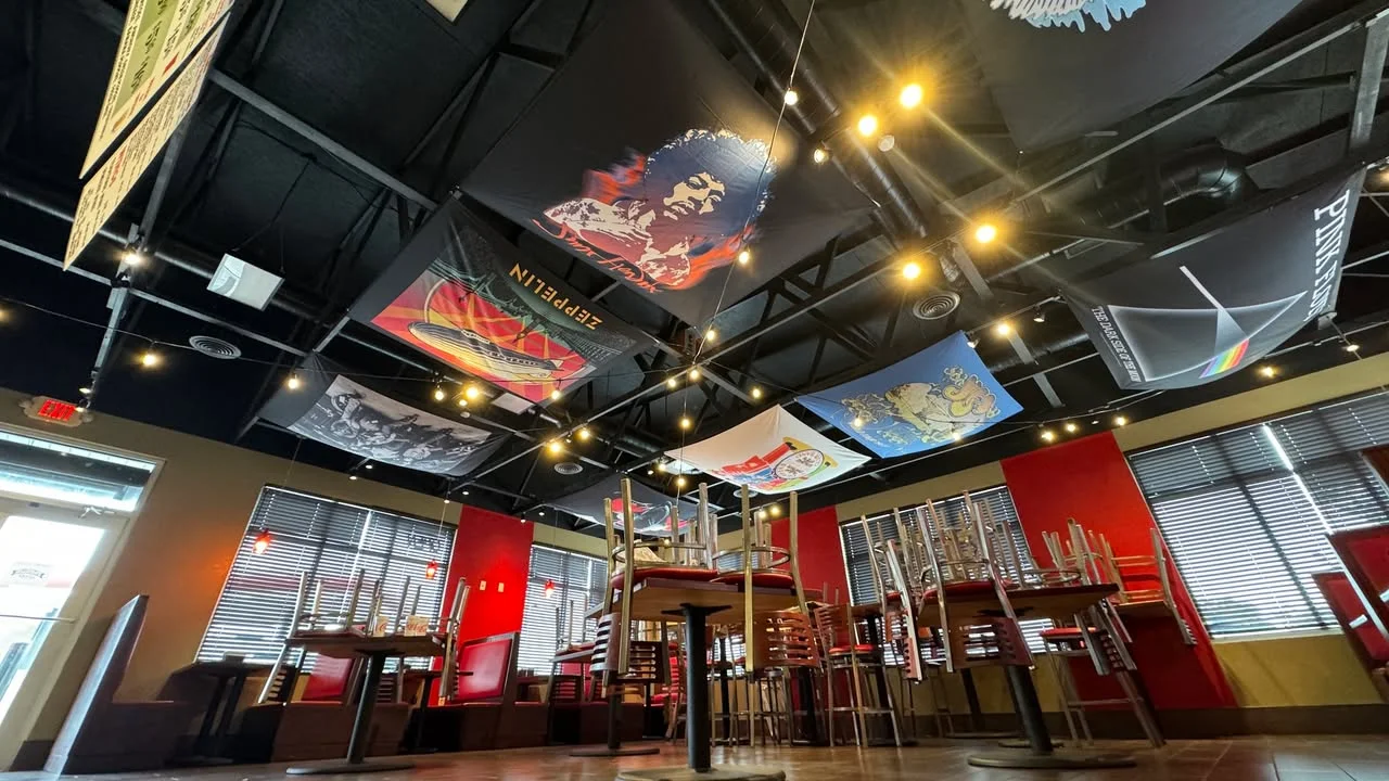 Eclectic restaurant interior with vibrant ceiling art