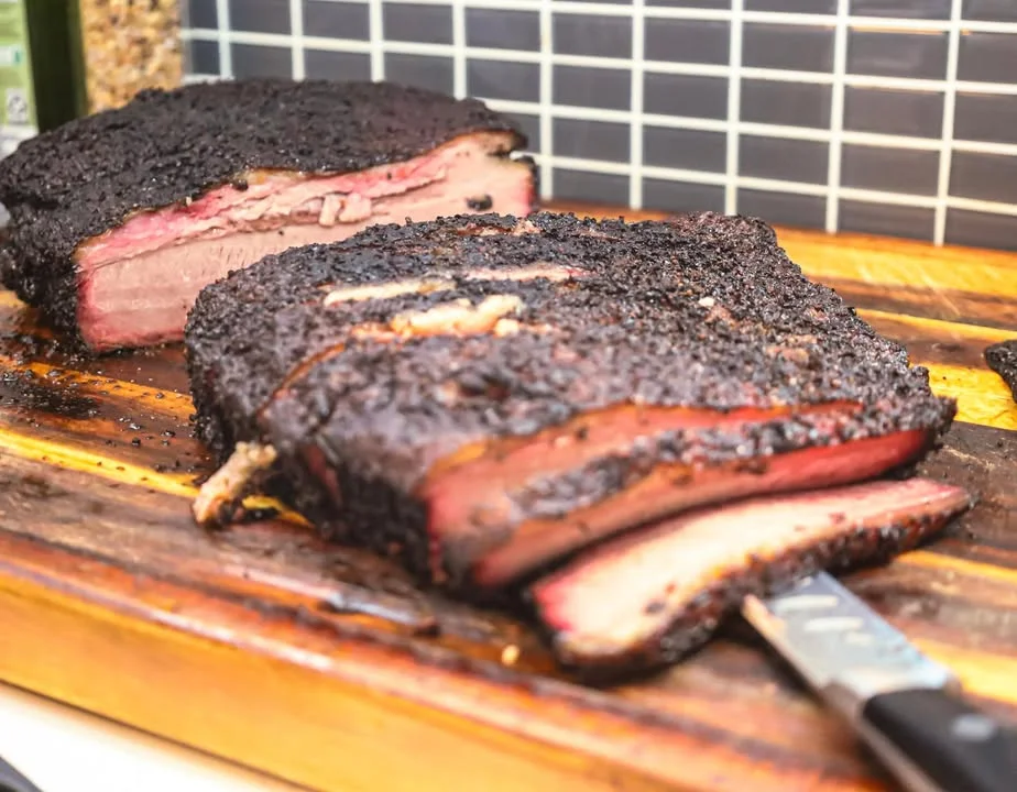 Smoked brisket sliced on a wooden cutting board
