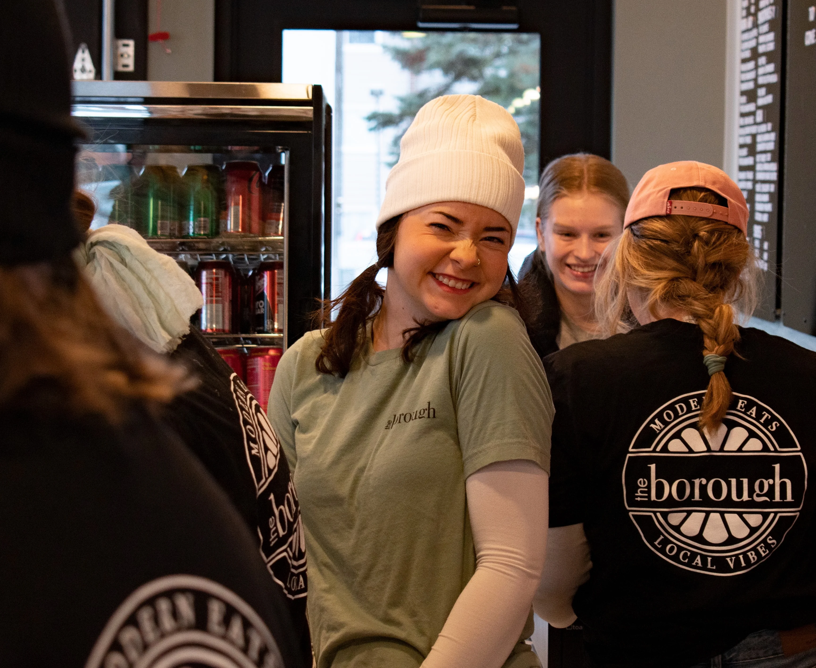 Borough Employee Smiling while another employee takes a customers order