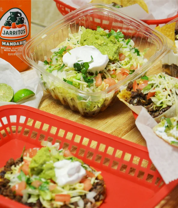 Colorful Mexican taco salad with guacamole and sour cream