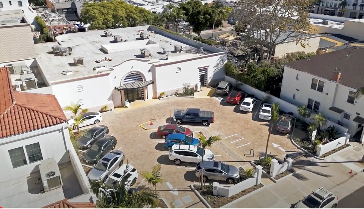 Aerial view of a restaurant parking lot with various cars