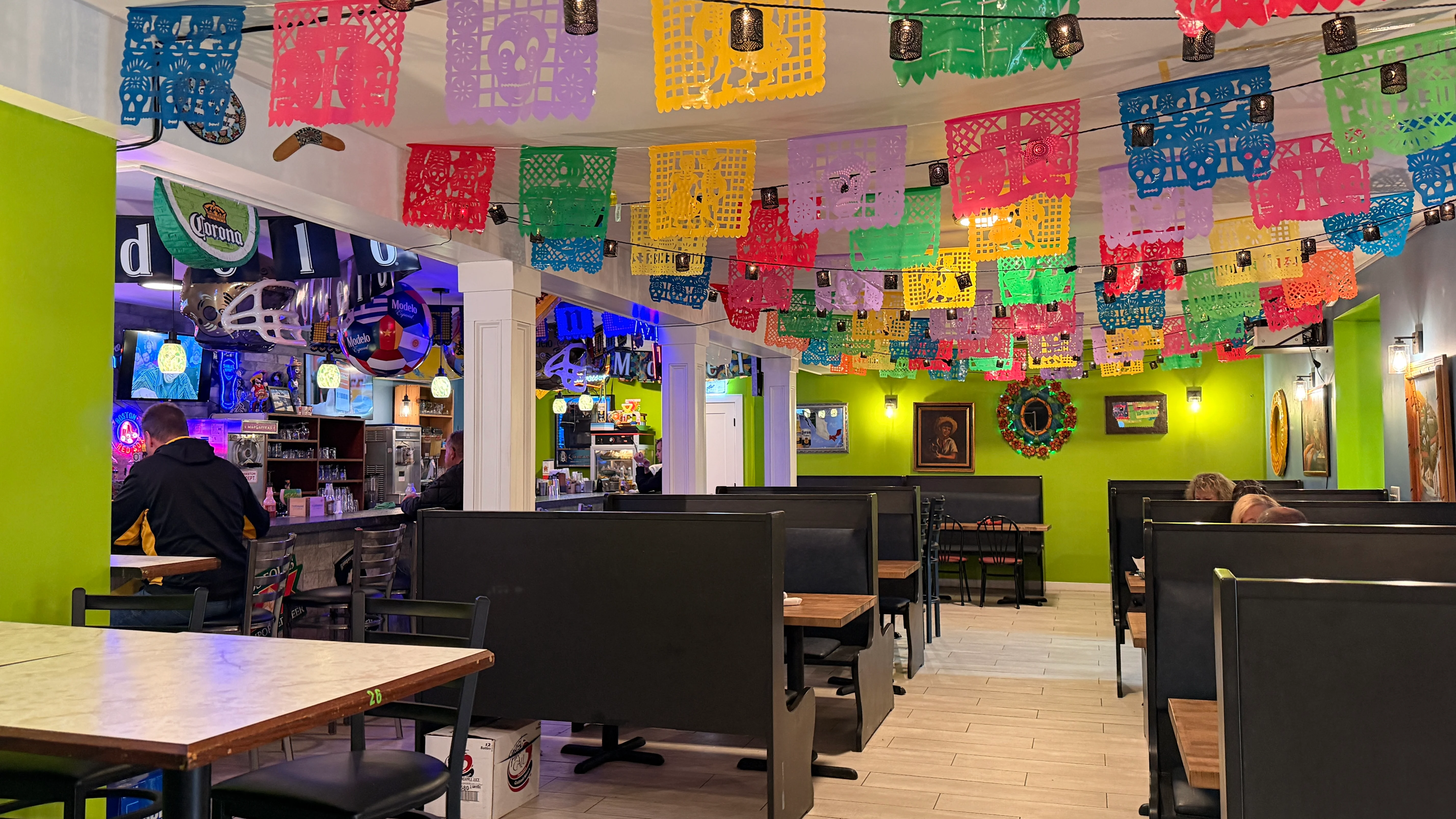 Colorful papel picado decorations in a vibrant restaurant interior.